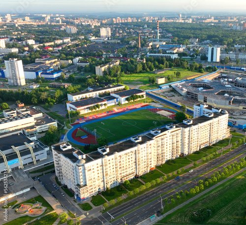 Urban landscape. Residential buildings and streets in city, top view. View of the city with multi-storey houses and buildings. City street, road traffic, cars on road. Many housing estates build.