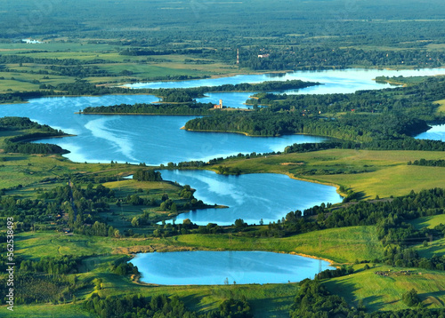 Lake landscape, aerial view. Chereiskoye Lake in Belarus. Pond in village with house. Global drought crisis. Island with forest in freshwater. Rural landscape, drone view. Drink water safe.