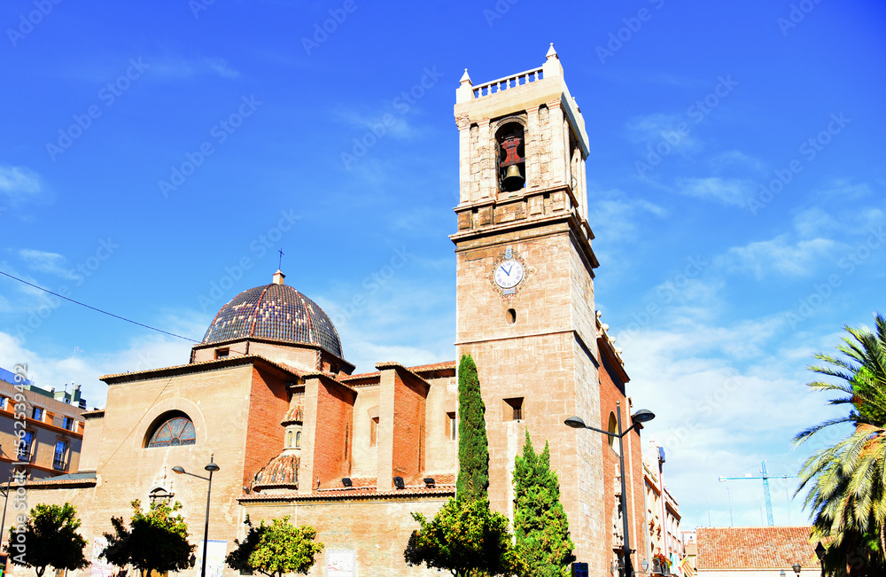 Ancient old building, spanish architecture. Old historical building in the Antique architectural style. Iglesia Santa María del Mar church in Valencia, Spain. Bell tower with clock.
