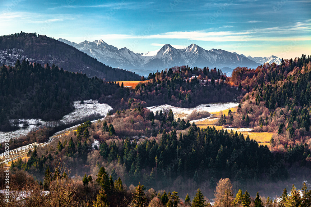 The awsome view of Tatra Mountains behind the colorful mixed forest, Poland
