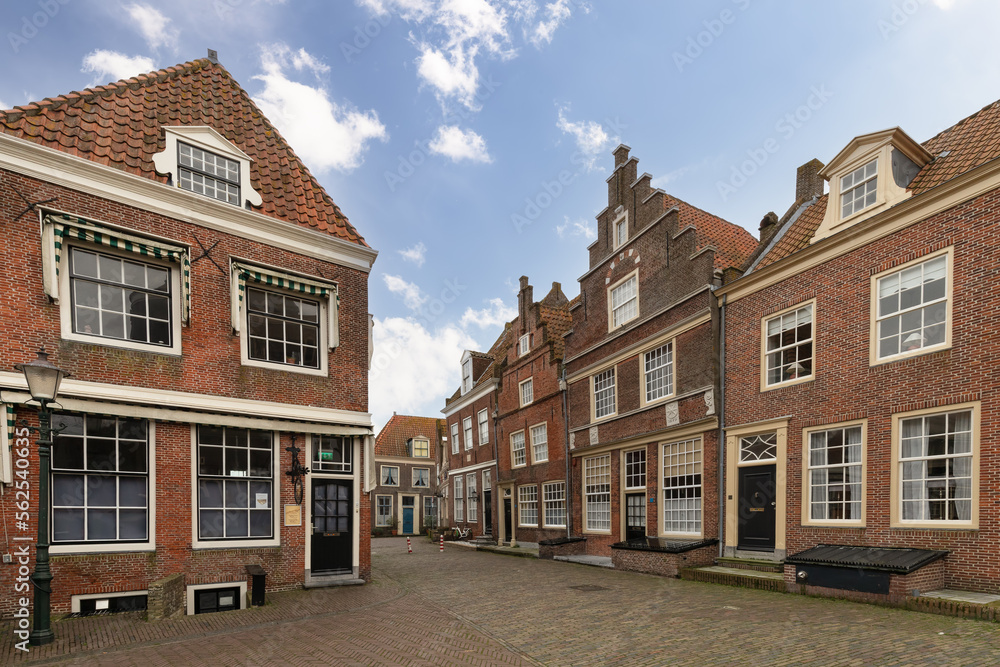 Street with historic buildings in the old historic center of the Dutch city of Enkhuizen.