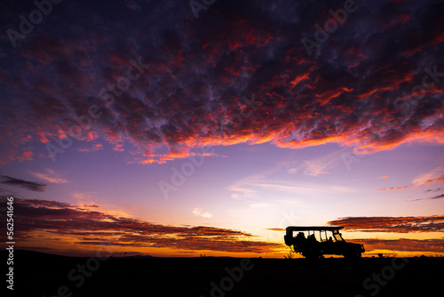 Silhouette of a safari truck at sunrise