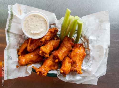 Spicy chicken wings with dressing and celery