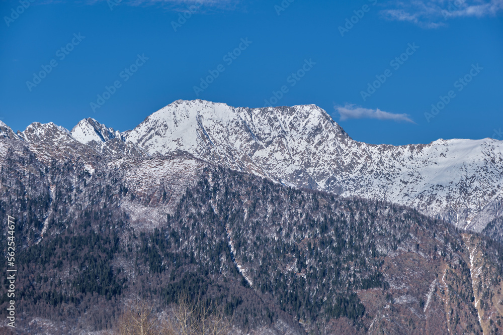 Mountains covered with snow against the blue sky