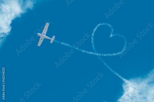Canvas Print flying plane among the clouds love heart sign