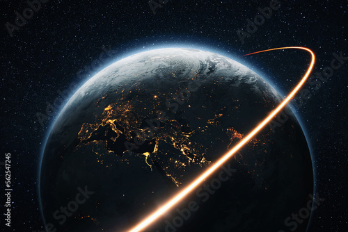 Space shuttle rocket flies with blasts and a light line around the night planet Earth with lights cities. Travel in space, concept. Space satellite flies near the planet earth. Starry space