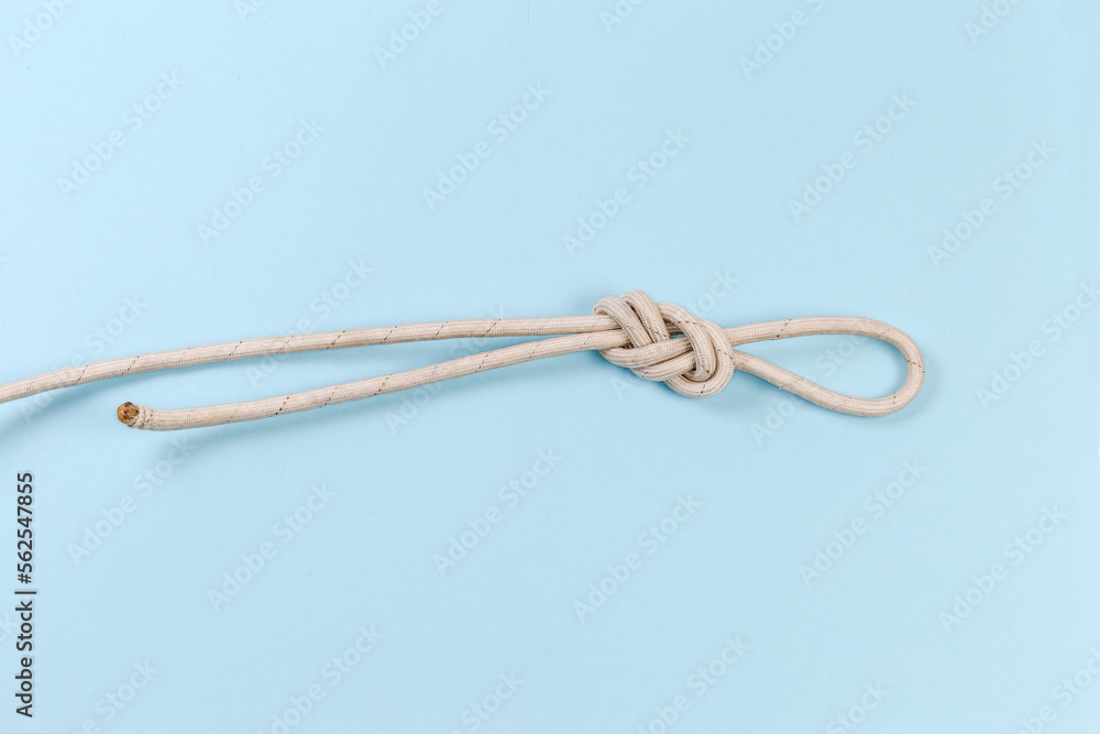 Rope knot as аigure-eight loop on a blue background Rope knot as аigure-eight loop on a blue background