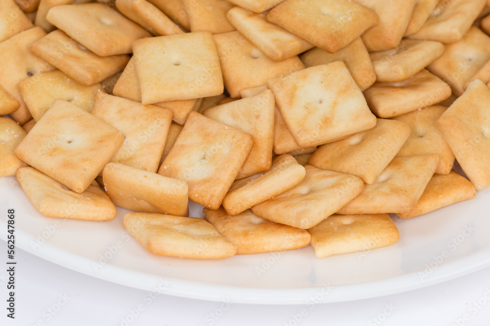 Salty crackers square shape on dish, fragment close-up Salty crackers square shape on dish, fragment close-up