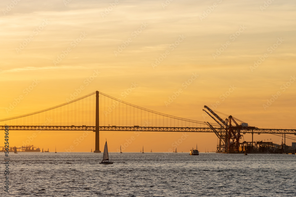 Fototapeta premium Bridge over the river and industrial cranes by the water
