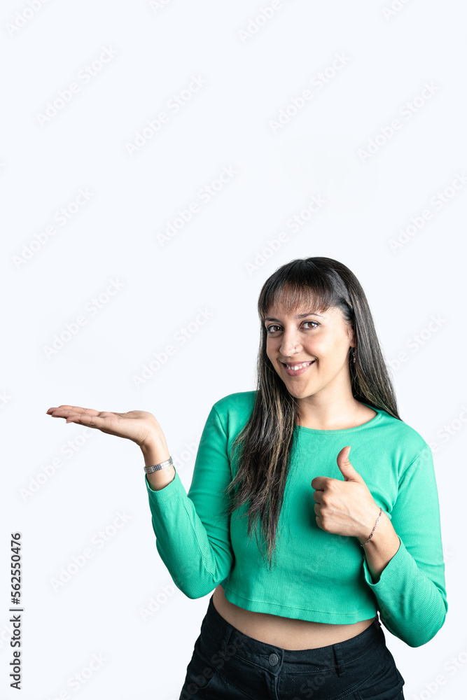 Young woman showing something on the palm of her hand. Isolated on white background. Vertical photography with isolated background Young woman showing something on the palm of her hand. Isolated on white background. Vertical photography with isolated background