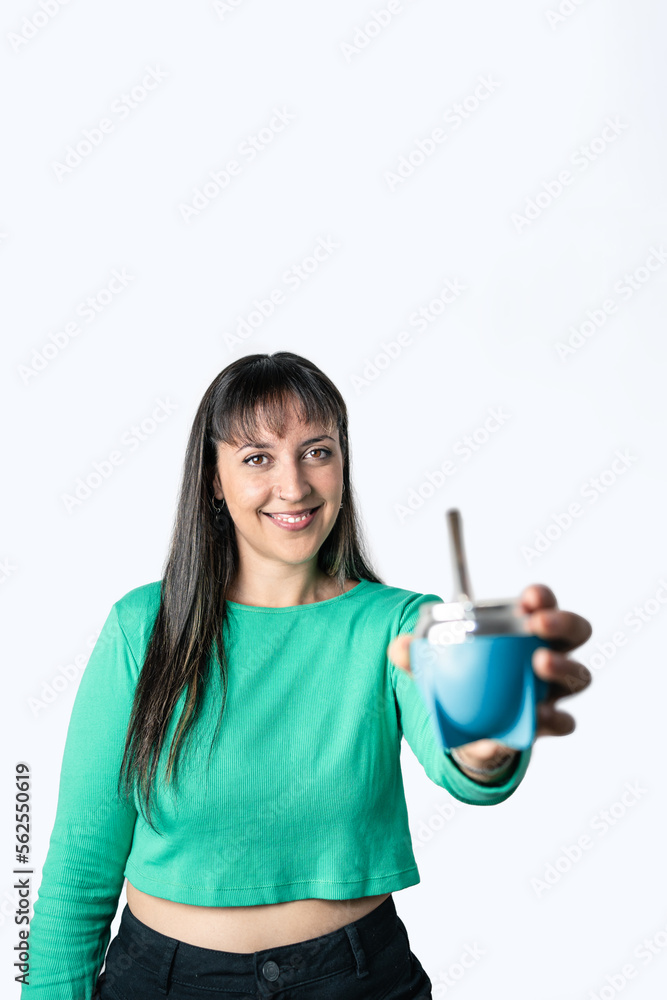 Latin woman offering mate, a South American drink made of yerba mate. Vertical photography over isolated white background Latin woman offering mate, a South American drink made of yerba mate. Vertical photography over isolated white background