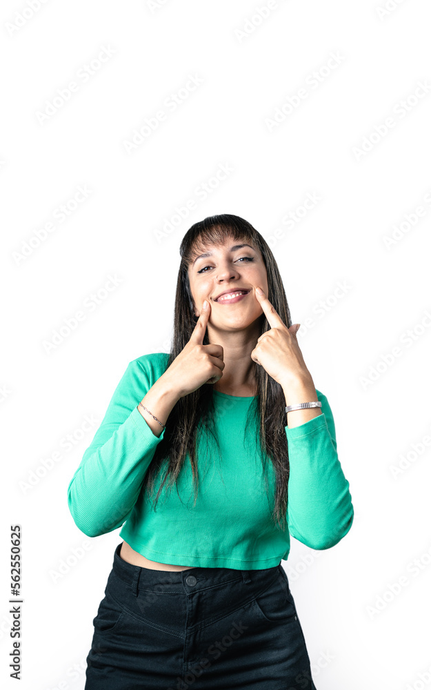 Real Latin woman making smiling gesture with hands over white background. Studio shot, isolated vertical shot. Real Latin woman making smiling gesture with hands over white background. Studio shot, isolated vertical shot.