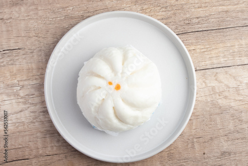 Steamed pork buns in a plate on a white background