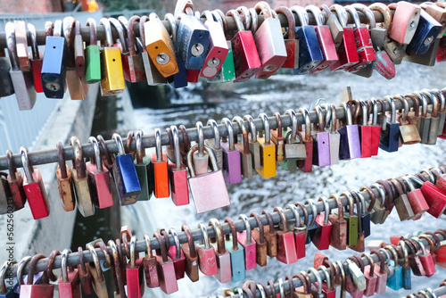multi-colored locks of lovers on a metal lattice