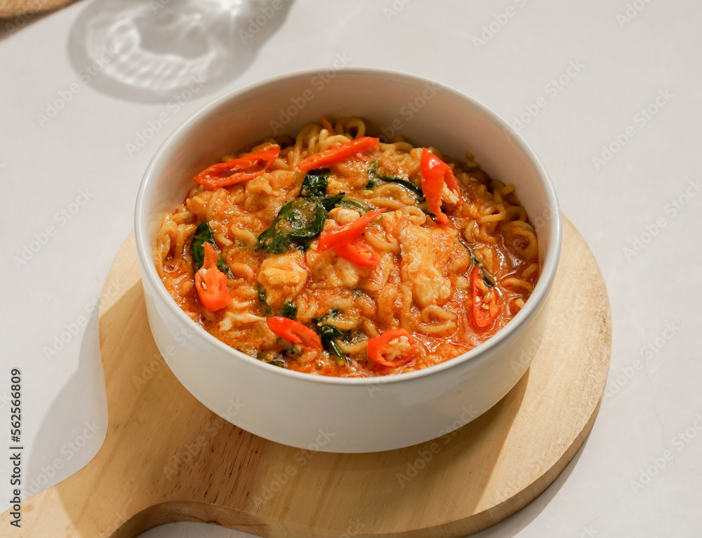 Spicy noodles with chili as a garnish in a white bowl Spicy noodles with chili as a garnish in a white bowl