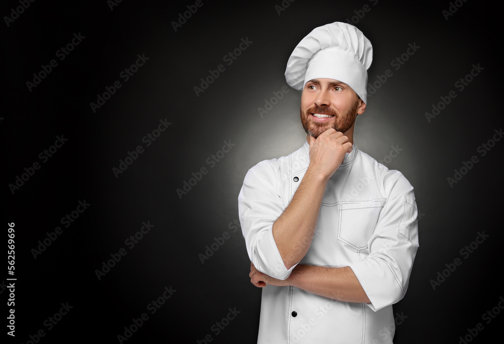 Smiling mature chef on black background, space for text Smiling mature chef on black background, space for text
