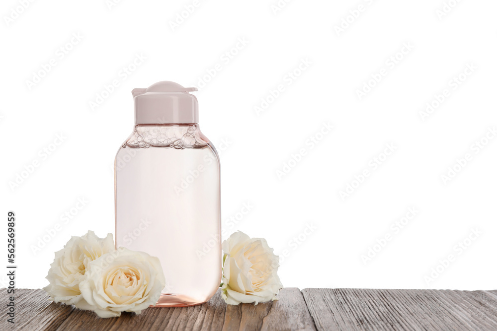Micellar water and roses on wooden table against white background. Space for text