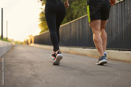 Sporty couple in fitness clothes jogging outdoors, closeup
