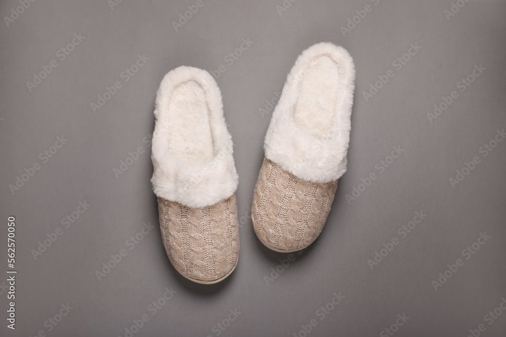 Pair of beautiful soft slippers on grey background, top view Pair of beautiful soft slippers on grey background, top view