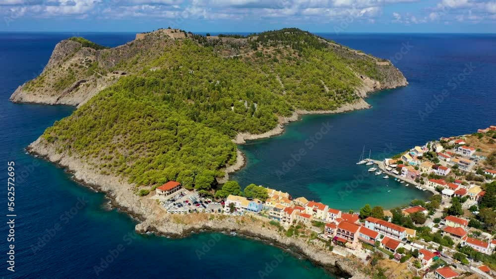 Assos village in Kefalonia, Greece. Turquoise colored bay in Mediterranean sea with beautiful colorful houses in Assos village in Kefalonia, Greece, Ionian island, Cephalonia, Assos village. Assos village in Kefalonia, Greece. Turquoise colored bay in Mediterranean sea with beautiful colorful houses in Assos village in Kefalonia, Greece, Ionian island, Cephalonia, Assos village.