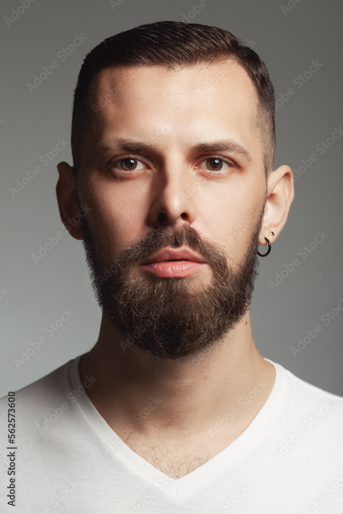 Male beauty concept. Portrait of proud charismatic active 30-year-old man posing over dark gray background. Perfect haircut. Hipster style. Close up. Studio shot Male beauty concept. Portrait of proud charismatic active 30-year-old man posing over dark gray background. Perfect haircut. Hipster style. Close up. Studio shot