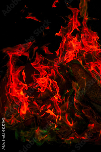  Variegated flames and colorful sparks close-up.Multicolored flame.Firewood burning in bonfire.Burning bonfire.magical colorful flame. 