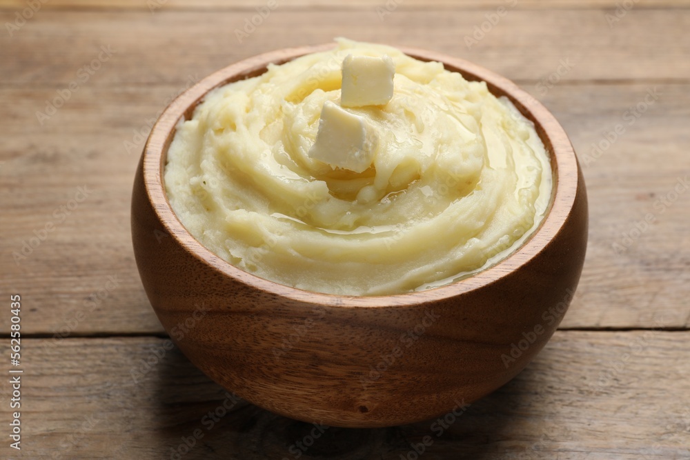 Bowl of delicious mashed potato with butter on wooden table, closeup Bowl of delicious mashed potato with butter on wooden table, closeup
