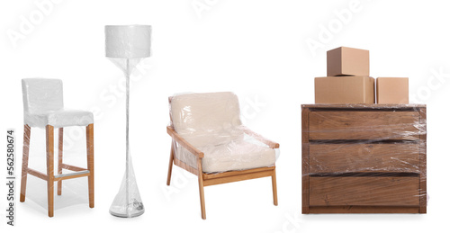 Furniture and lamp wrapped with stretch film and cardboard boxes on white background