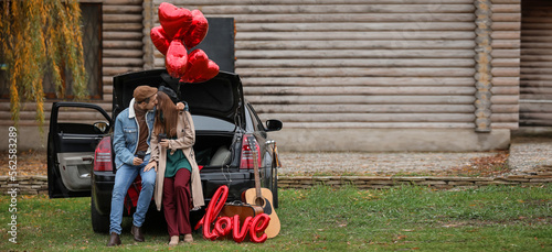 Happy young couple near car...