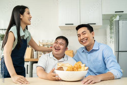 Asian happy family, mature parents baking bakery with son in kitchen