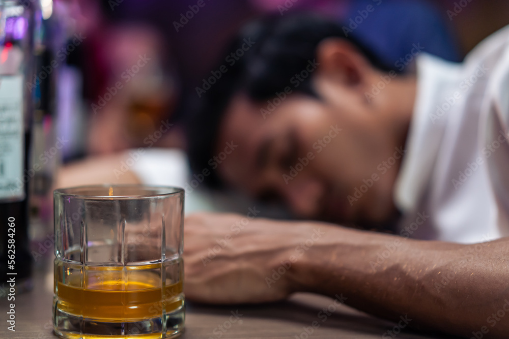 Asian depression man feeling heart broken and drinking beer in a bar. Asian depression man feeling heart broken and drinking beer in a bar.