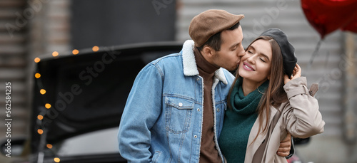 Happy young man kissing his...
