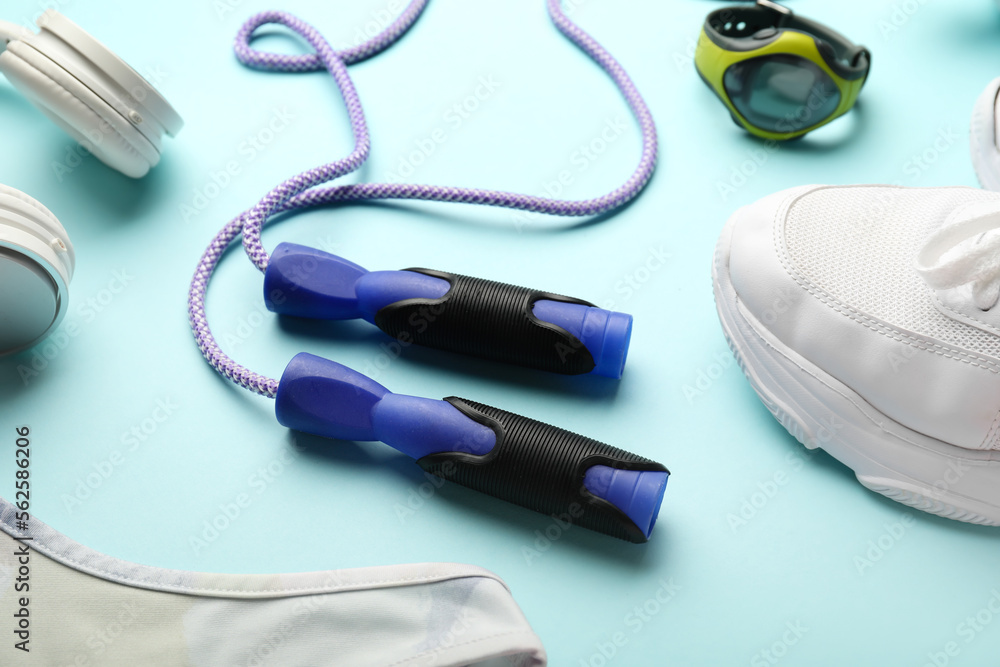 Skipping rope on blue background, closeup Skipping rope on blue background, closeup