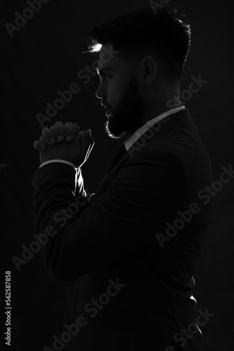 Silhouette of young man pra...
