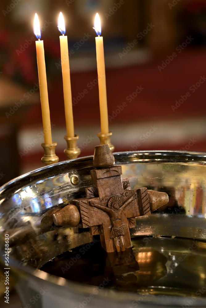 Old wooden cross with a carved Savior, submerged in Holy Water Vessel ...