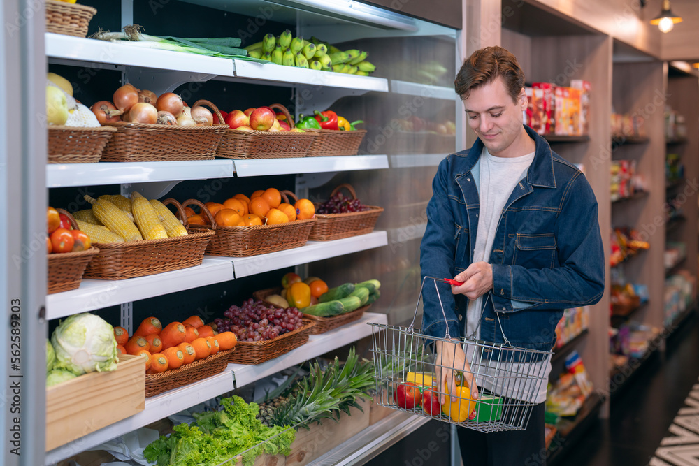 An European man buy a fruit and vegetable from refrigerator cold