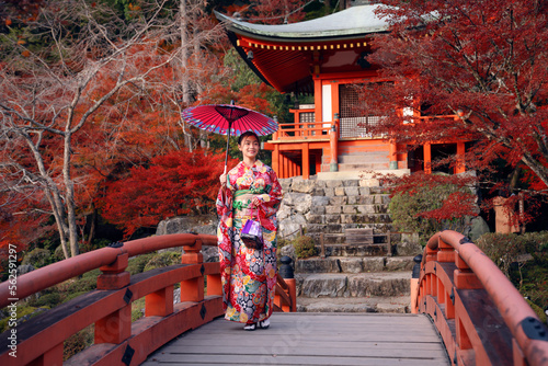 Photography Japanese girl in Kimono dress smile in Daigoji temple with pond bridge pagoda an