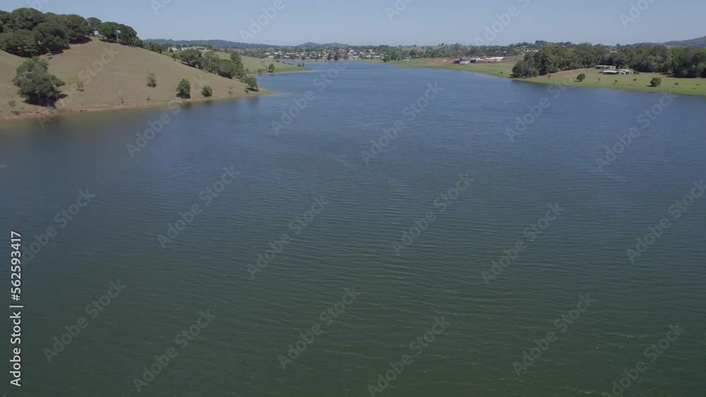 Tranquil Waters Of Lake Tinaroo Surrounded By Lush Greenery In Yungaburra Town, Atherton Tablelands, Australia. aerial, pan right Tranquil Waters Of Lake Tinaroo Surrounded By Lush Greenery In Yungaburra Town, Atherton Tablelands, Australia. aerial, pan right