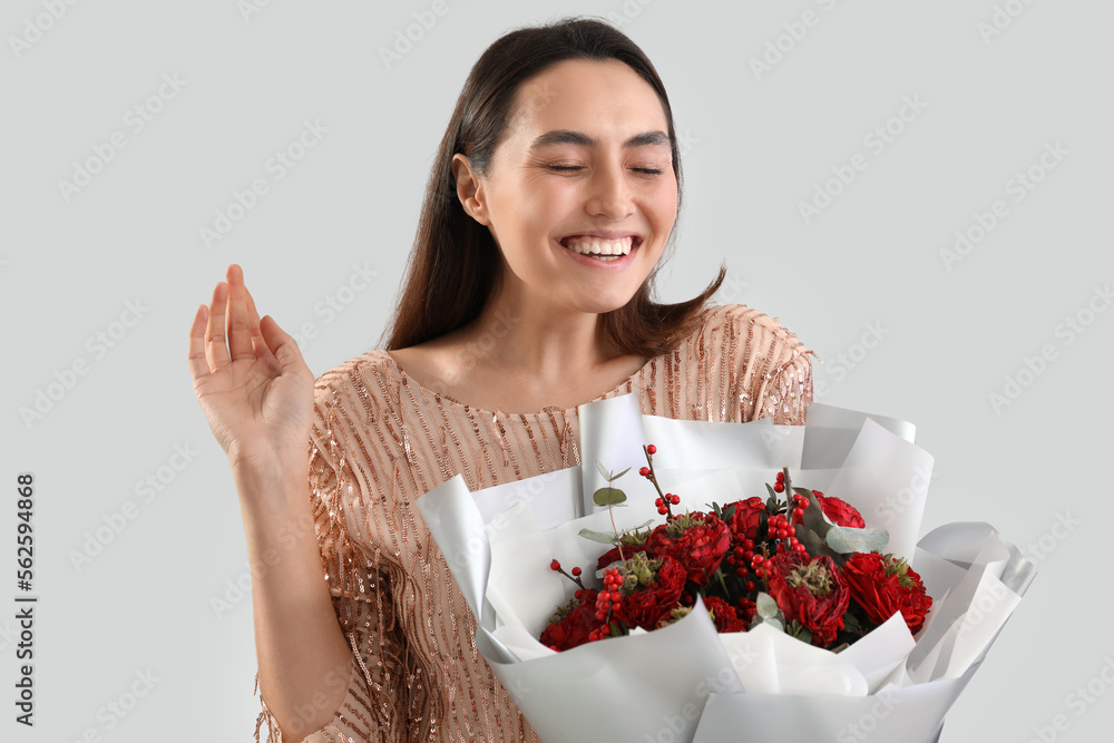 Young woman with bouquet of flowers on light background. Valentine's Day celebration Young woman with bouquet of flowers on light background. Valentine's Day celebration