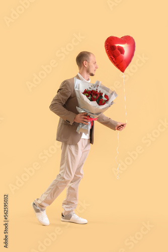 Young man with bouquet of f...