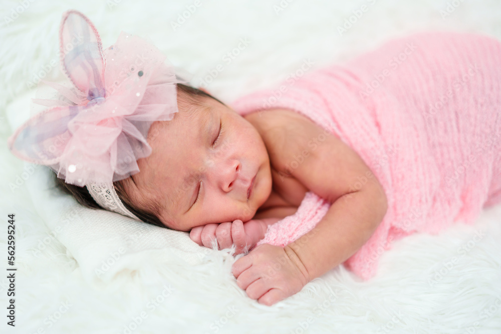 newborn baby girl sleeping in cloth wrap blanket on bed newborn baby girl sleeping in cloth wrap blanket on bed