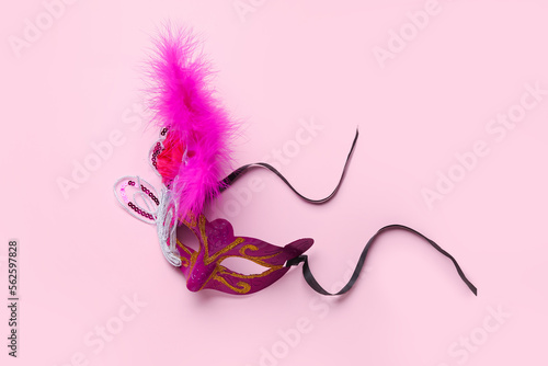 Beautiful carnival mask for Mardi Gras celebration on pink background