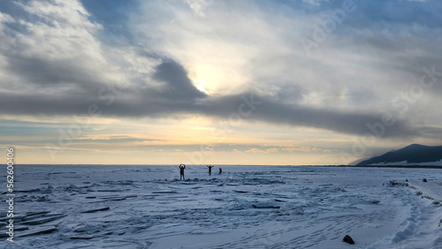 Winter sea sunset. Panoramic view of the snow-covered shore of the frozen sea  the lake at sunset. Shards of ice close-up. Christmas  seasons  winter.  Selective focus.