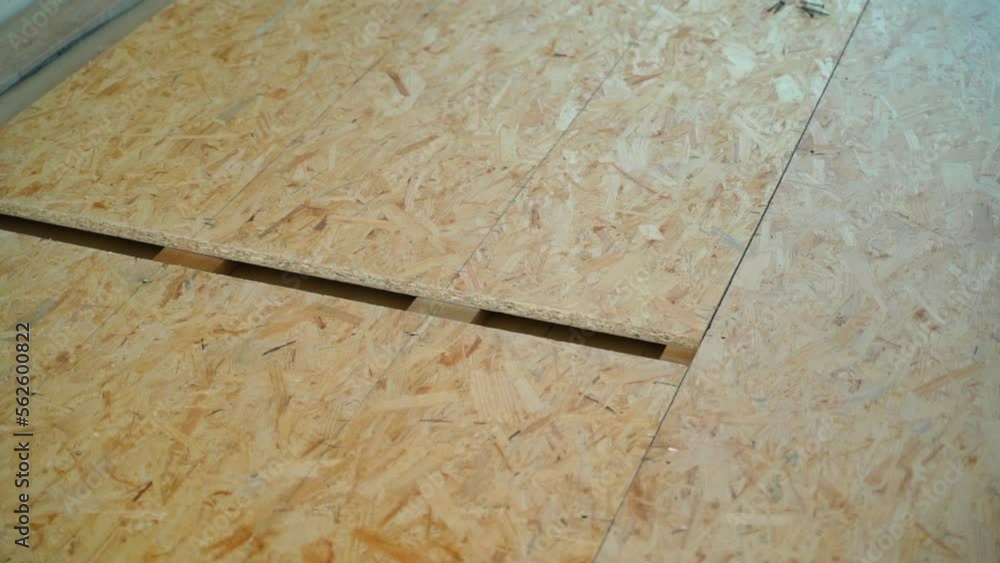 Closeup of an installed subfloor made of oriented strand board