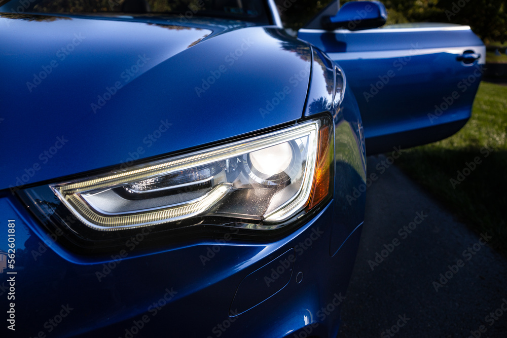 Headlight of a blue car.