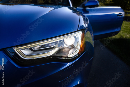 Headlight of a blue car. © Saundi