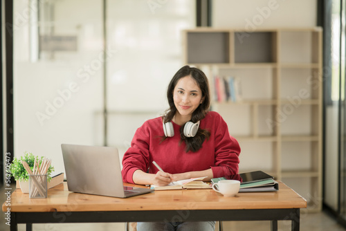 Asia businesswoman working on digital tablet executives meeting in an office using laptop...