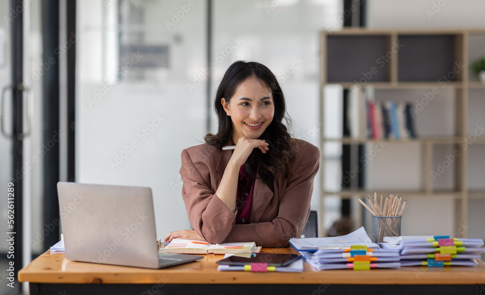 Freelancer Happy business Asian woman in knitwear taking notes at laptop sitting at desk office, finance concept.
Freelancer Happy business Asian woman in knitwear taking notes at laptop sitting at desk office, finance concept.