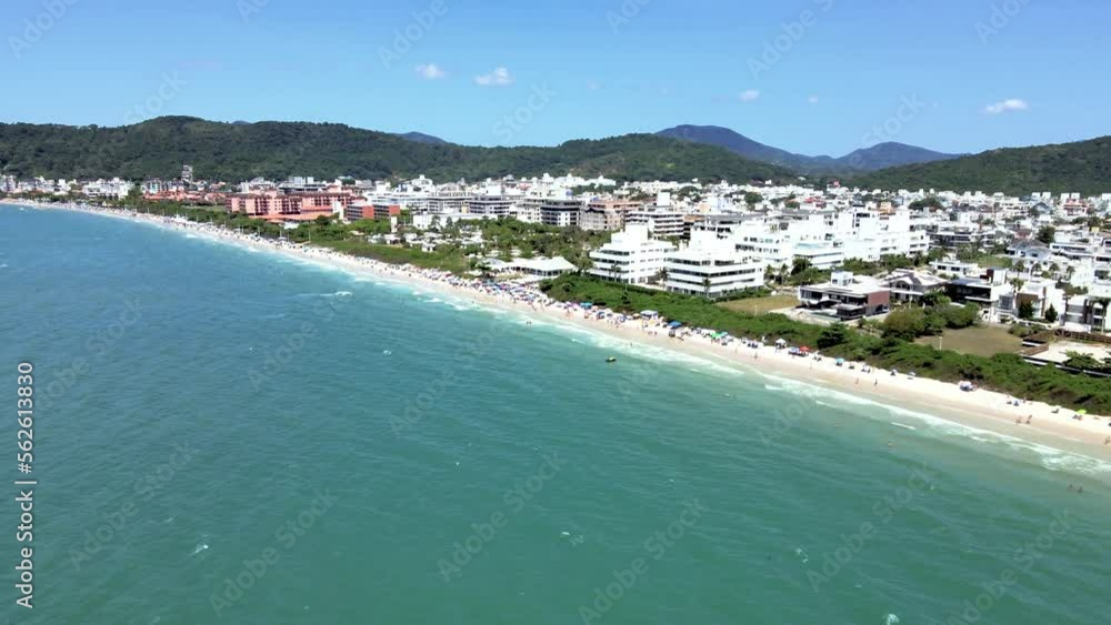 Aerial drone scene of upscale touristic beach in Florianopolis Brazil with many people on the beach and buildings in front of the sea with beautiful blue ocean jurere internacional Aerial drone scene of upscale touristic beach in Florianopolis Brazil with many people on the beach and buildings in front of the sea with beautiful blue ocean jurere internacional