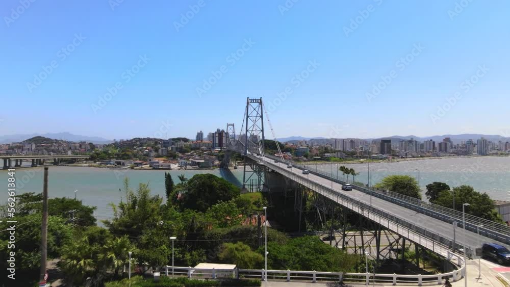 Drone aerial scene of Hercílio Luz bridge with large capital city urban complex Florianópolis with metallic suspension bridge sun setting with bridge and urbanism center Drone aerial scene of Hercílio Luz bridge with large capital city urban complex Florianópolis with metallic suspension bridge sun setting with bridge and urbanism center